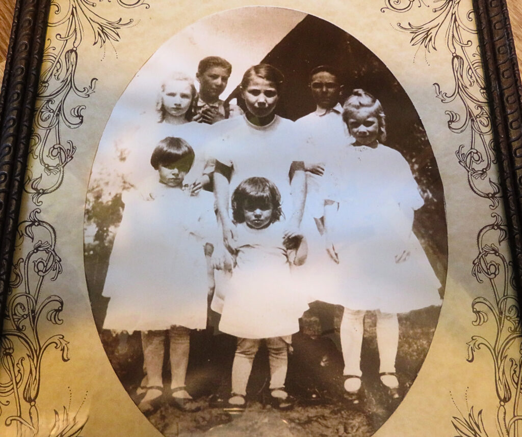 Grandma Carol is the older child in the center of the photo, taken around 1922.